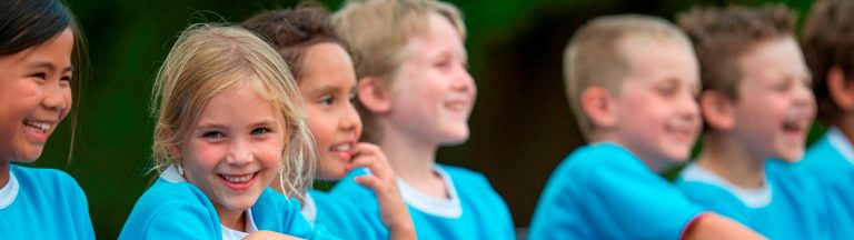 kids-sitting-beside-soccer-field